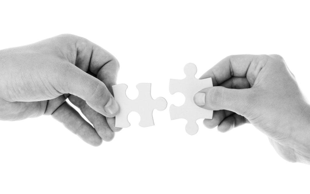 Two hands holding jigsaw pieces representing transactional emails