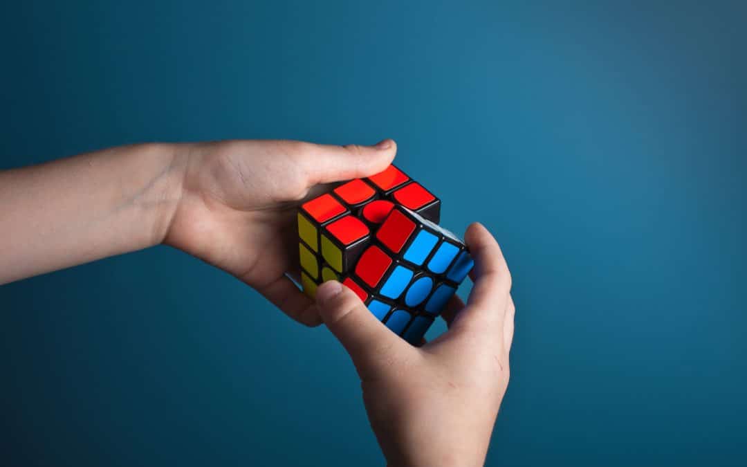 Hands successfully solving a Rubik's Cube that symbolizes tricks for solving email marketing challenges